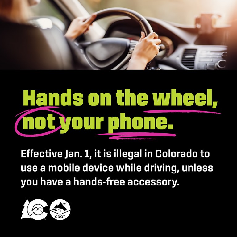 Hands on the wheel - not your phone Person driving with both their hands on the steering wheel. Text overlay reads "hand son the wheel, not your phone"