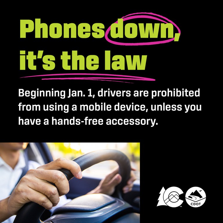 Phones down, it's the law Person driving with both hands on the wheel. Text overlay reads "Phones down, it's the law"